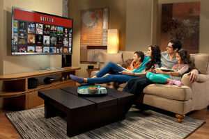 Family watching Netflix together on couch, browsing English content for language learning